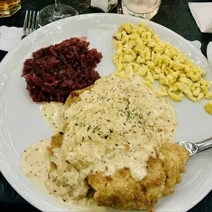 Schnitzel with mustard, cream sauce, cabbage and spaetzle.