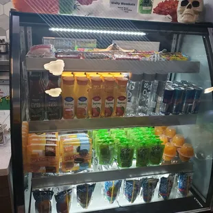  a display case filled with drinks
