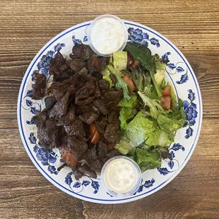 Beef Shawarma Plate - Slices of beef shawarma grilled with tomatoes &amp; served with tahini, rice, salad, tzatziki &amp; pita
