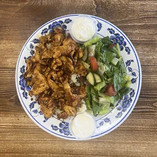 Chicken Pomegranate Plate - Slices of chicken shawarma marinated in pomegranate molasses served with rice, salad, garlic, tzatziki &amp; pita