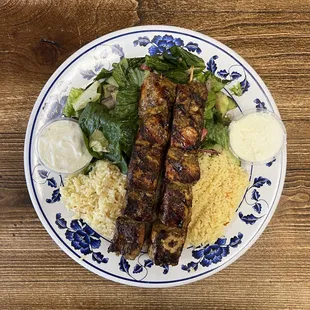 Chicken Kabobs Plate - 2 chicken skewers served with rice, salad, tzatziki, garlic &amp; pita