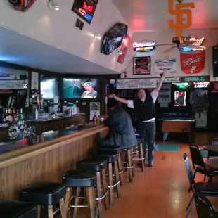 a bar with stools and tables