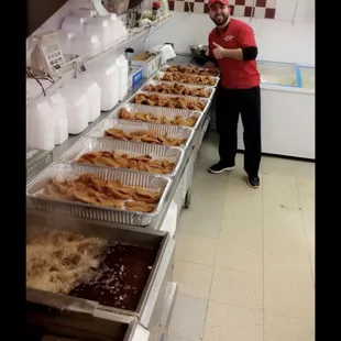 a man standing in front of a line of food