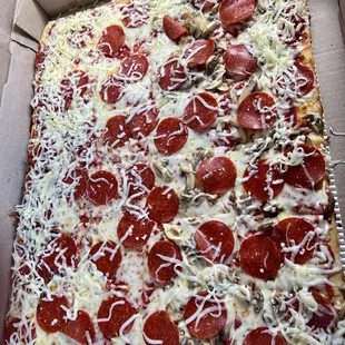 Full tray with pepperoni and half also with mushroom