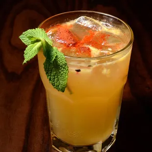 AÑEJO GINGER JULEP, This Cazadores Añejo Tequila cocktail is crafted with muddled orange, mint, Sweet &amp; Sour, Ginger Beer and a little