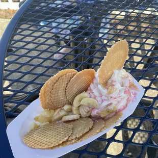 Strawberry swirl ice cream with fresh banana and waffle cone nachos