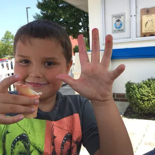 Almost done with his cotton candy flavored cone
