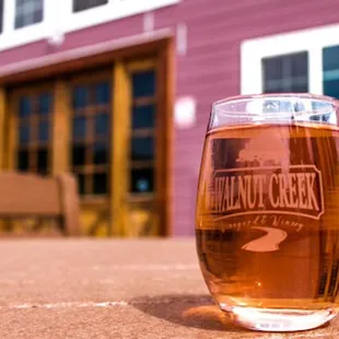a glass of beer sitting on a table