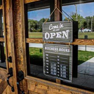 open sign in front of business hours