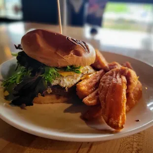 a burger with bacon and lettuce