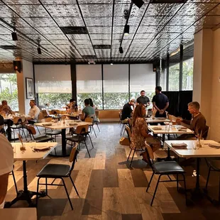 people sitting at tables in a restaurant