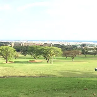 Hole 5, the tee box is elevated I've the green and it is overlooking Honolulu Harbor in the distance.