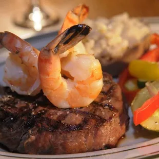 a steak with shrimp and vegetables
