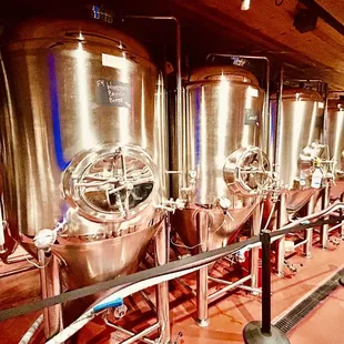 a row of stainless steel tanks