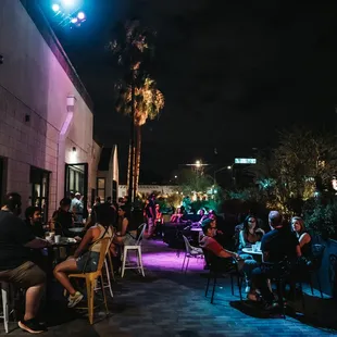 a crowd of people sitting outside at night