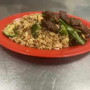 Mongolioan Beef with Fried Rice Marinated Flank Steak,  mushrooms and Scallions stir fried in a sweet mongolian sauce.