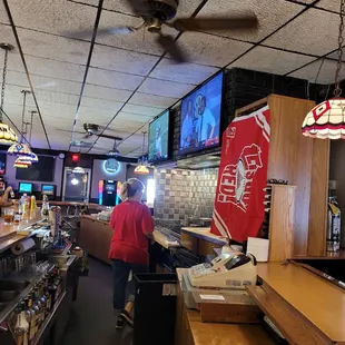 a man in a red shirt at the bar