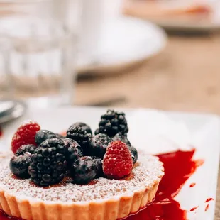 a dessert with berries and powdered sugar