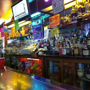 a row of liquor bottles on a bar