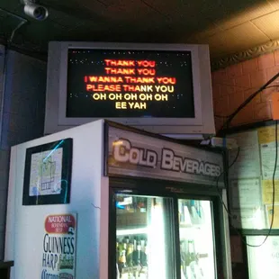 Karoake screen on top of the beer fridge