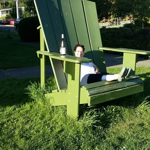 a woman sitting in a green chair