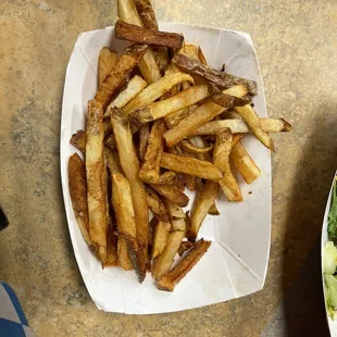 a plate of fries and salad