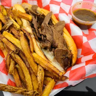 a plate of french fries and a pulled pork sandwich