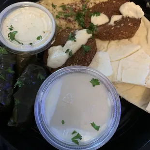Mini sampler with grape leaves, babaganoush, falafel, tahini