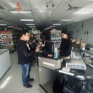 two men standing at the cash register