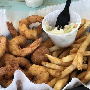 Shrimp, fries, hush puppies and cole slaw