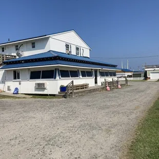 Front of Marina and Grill.  Grassy area includes picnic tables.