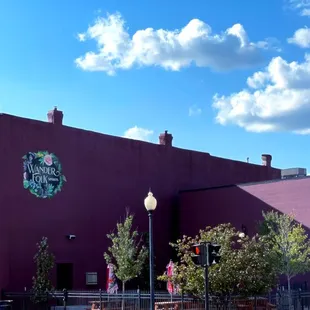 a purple building with a green sign