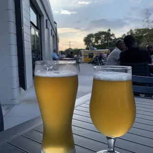 two glasses of beer on a table