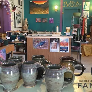 Inside the gallery, featuring beautiful glazed mugs.