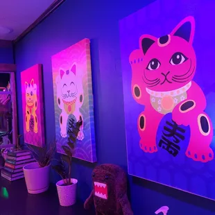 a pink cat and a purple cat