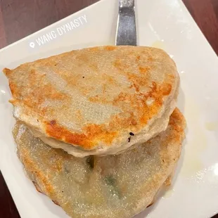 a stack of pancakes on a plate with a fork