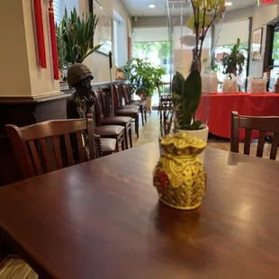 a vase of flowers on a table in a restaurant