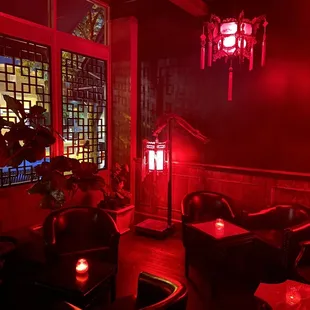 a dimly lit restaurant with red lighting