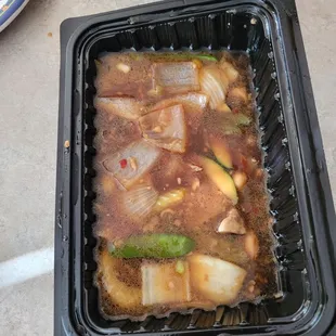 a person holding a container of food