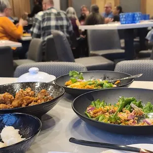 a table with bowls of food and drinks