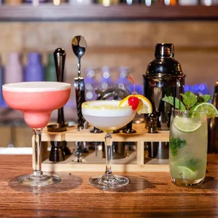 three cocktails on a bar