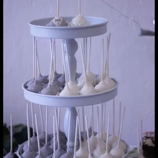 a three tier cake stand with cupcakes and marshmallows