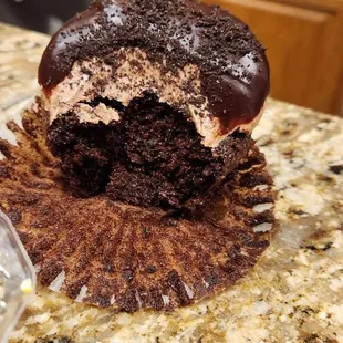 a half eaten chocolate cupcake