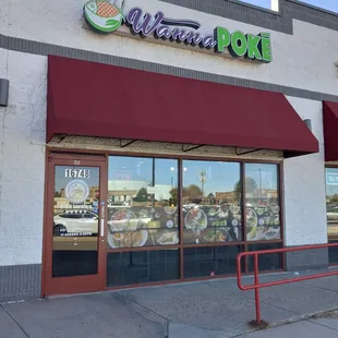 the front of a restaurant with a red awning