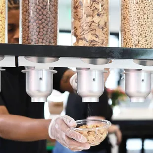 a person holding a bowl of cereal
