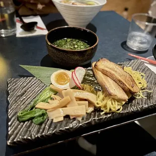 Tsukemen - chicken-based dipping broth, with ramen noodles served cold, chashu pork, bok choy, bamboo, marinated egg, scallions
