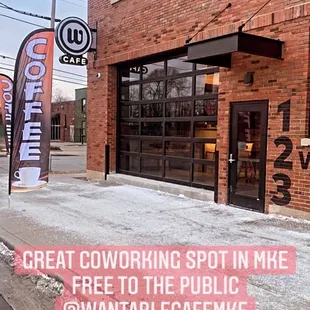 a brick building with a sign that says great coworking spot in me free to the public