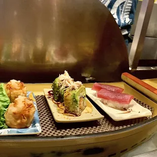 One of many sushi boats constantly refilled at the 30-seat sushi bar island.