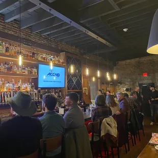 Decent sized bar seating for drinks and food. They frequently have the sports games on.