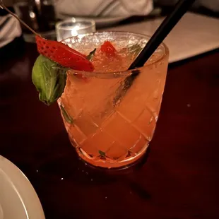 a closeup of a drink with strawberries and mint